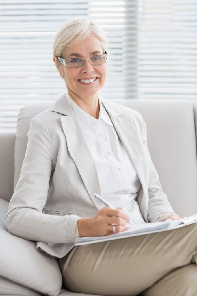 Portrait of smiling therapist in office