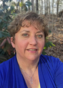 Portrait of Lori Manson, Problem Gambling Services Coordinator smiling in professional attire.