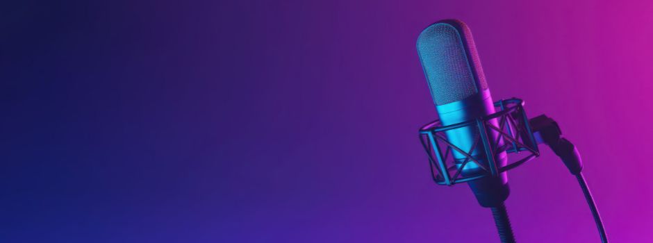 Purple background with a microphone in the foreground.
